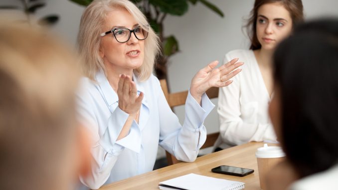 Attractive Aged Businesswoman, Teacher Or Mentor Coach Speaking